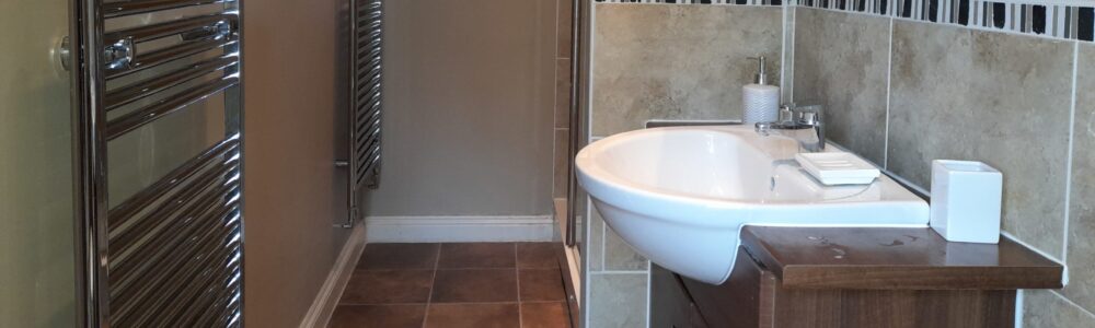 20220428_114355 Walk-in shower room with two towel radiators, w/c, hand basin and mirror wall unit with shaving point, at The East Wing Rufford Park Lodge