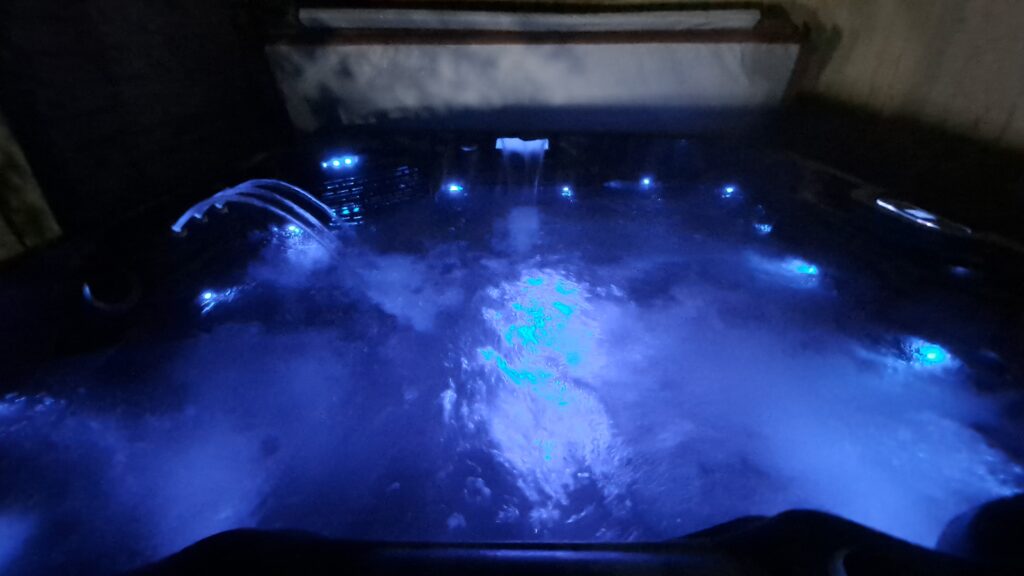 Hot Tub with blue light selected from 8 presets including Rainbow sequence, at Rufford Park Lodge.