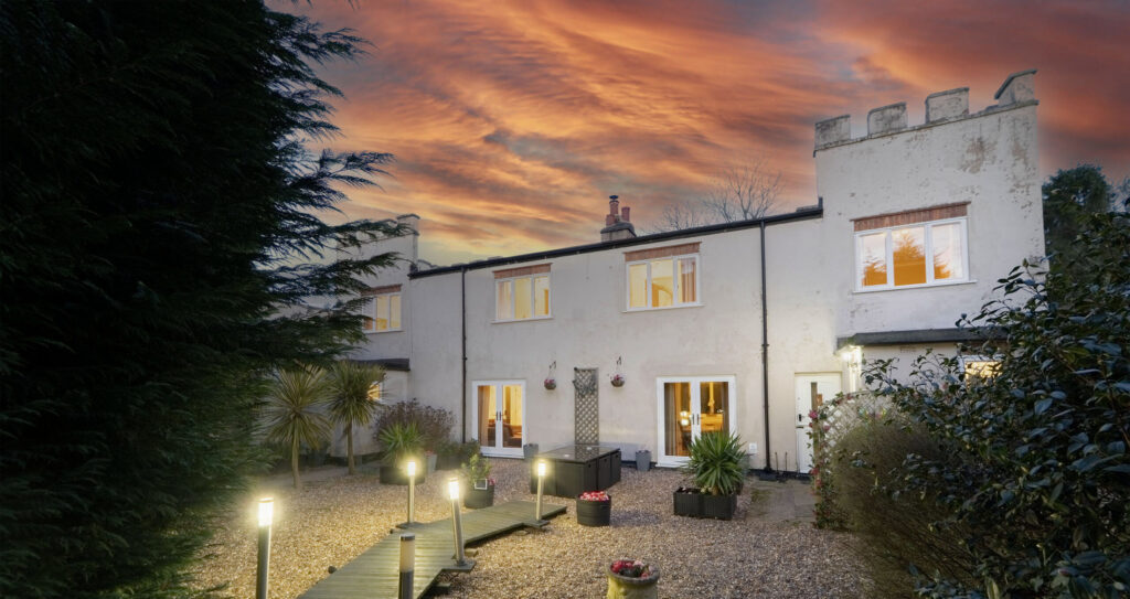 Courtyard at dusk with illuminated post lights